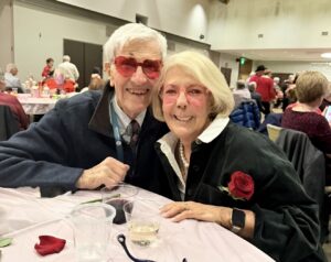 A cute couple posing together at the Valentine's Day dance.