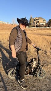 A man on a bike with his dog.