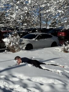 Karl doing a snow angel in the snow.