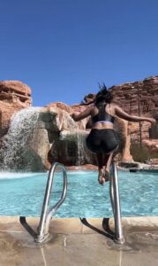 Miti jumping into a pool filled with water.