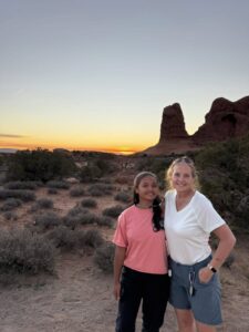 Quantz and Miti together in front of a red sunset.