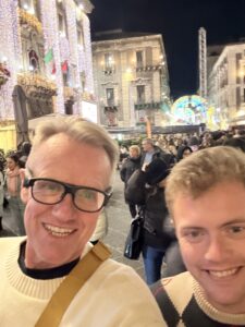 Karl and Nicholas together on a busy street.