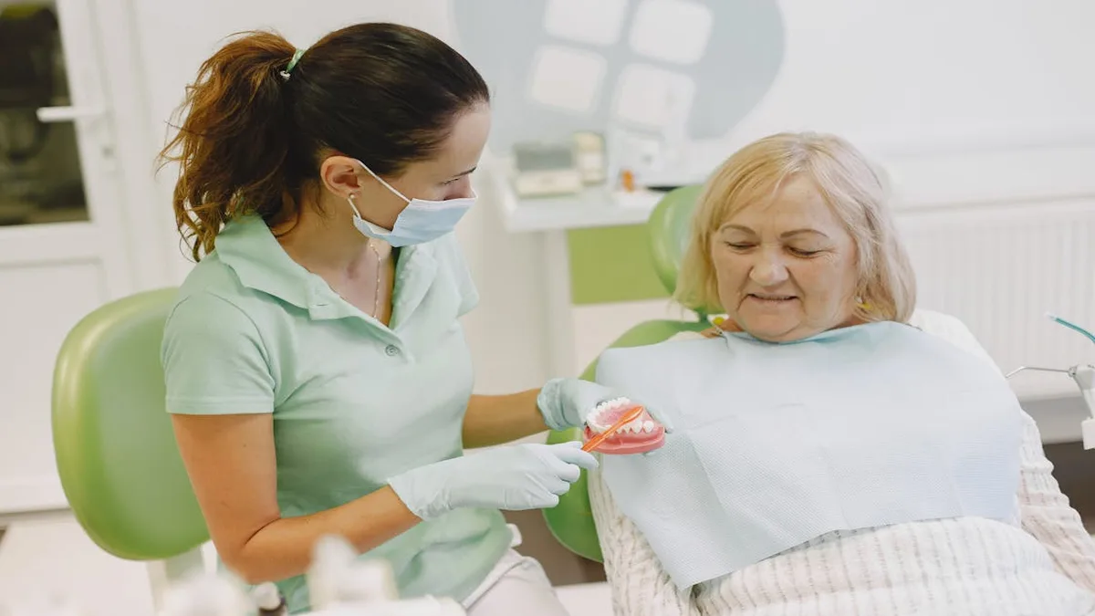 Senior woman smiling while dental professional explains Medicare dental coverage options