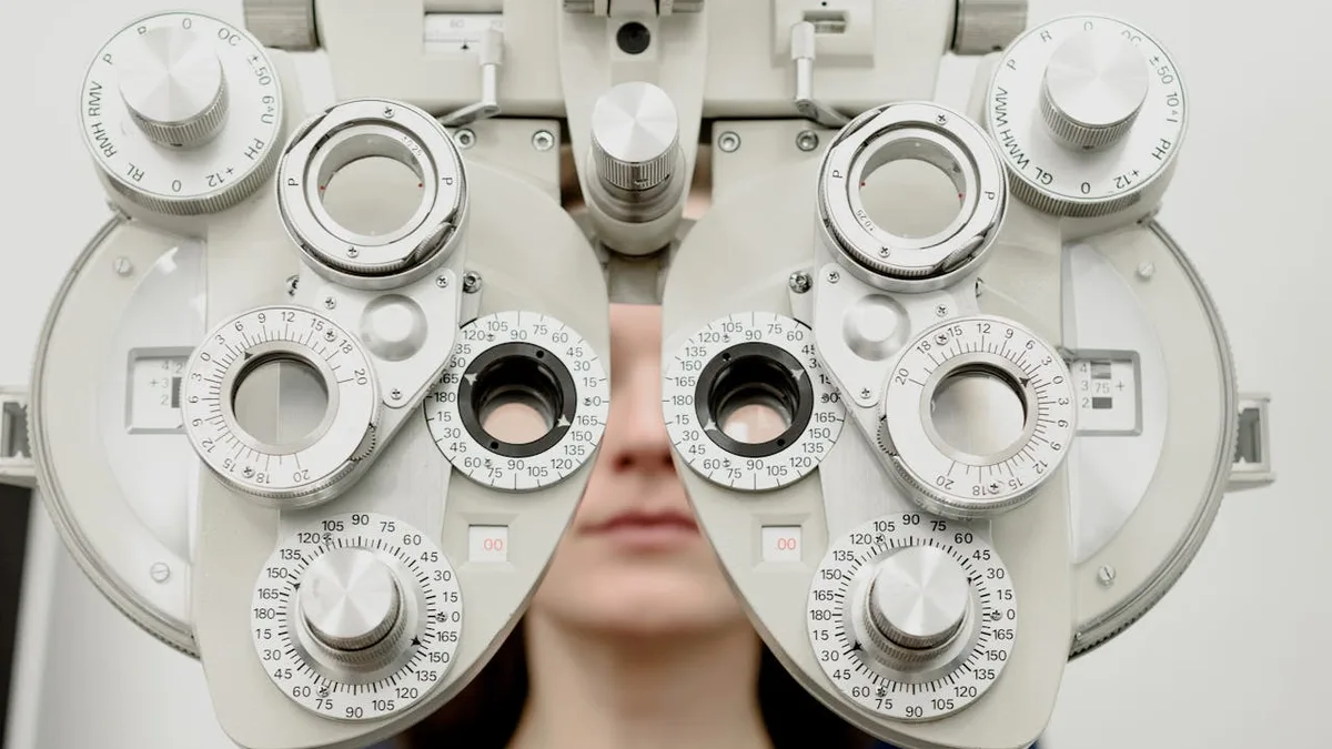 Senior woman receiving an eye exam at an optometrist office, representing Medicare vision coverage options