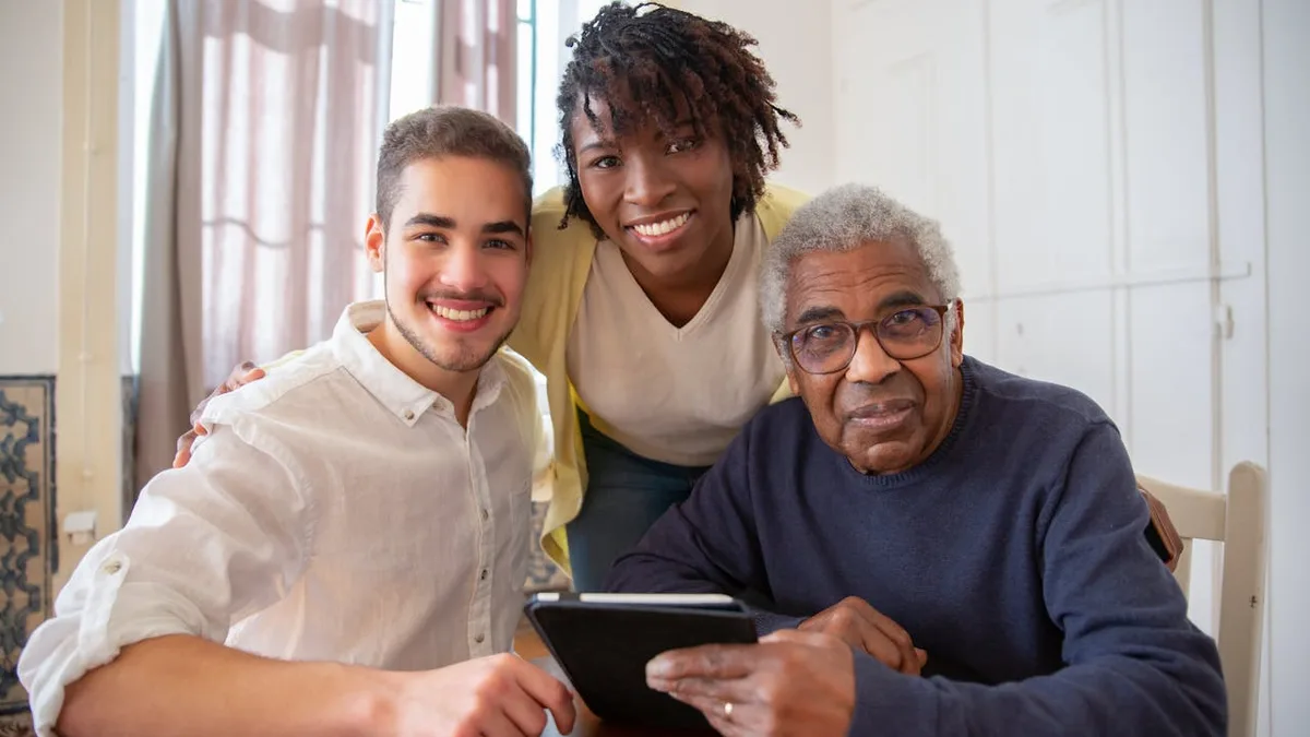 Family helping a senior review Medicare insurance plan options on a tablet