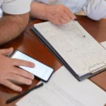 Senior couple reviewing Medicare Supplement Plan N insurance documents at kitchen table