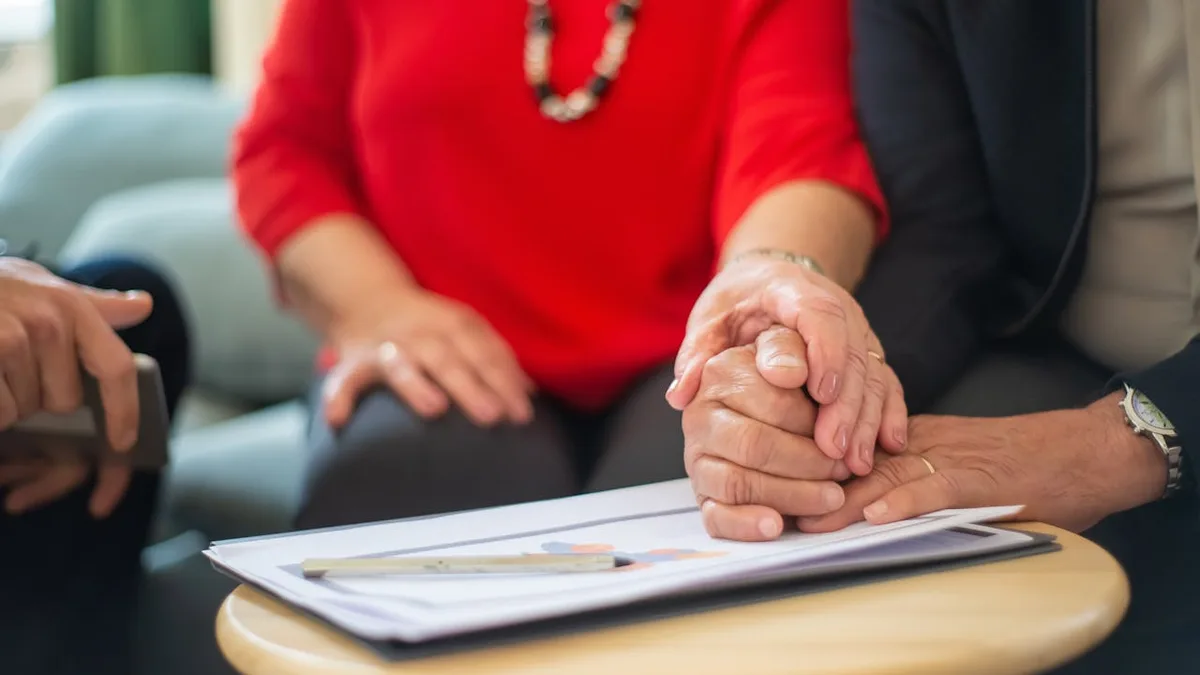 Senior couple consulting with a Medicare advisor about Medicare vs Medicaid differences