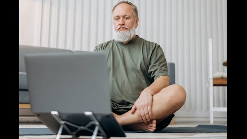 Senior man researching Medicare coverage options on laptop