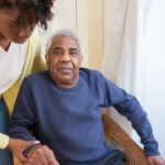 Senior man receiving caring assistance, representing the support Medicare provides to Americans aged 65 and older