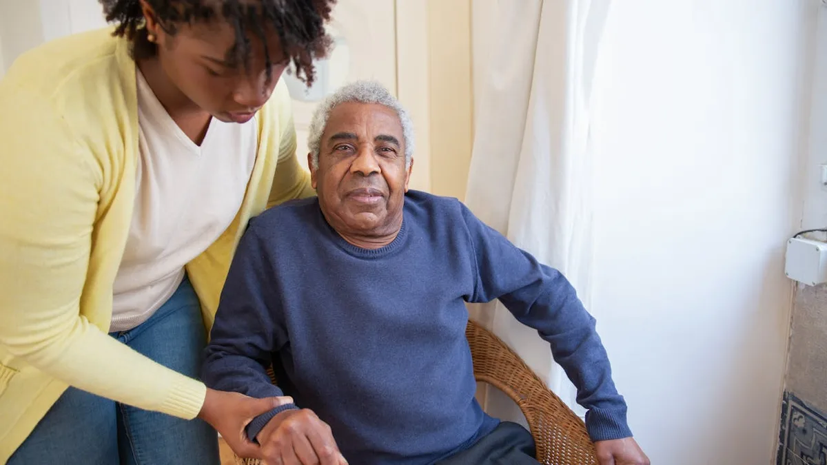 Senior man receiving caring assistance, representing the support Medicare provides to Americans aged 65 and older