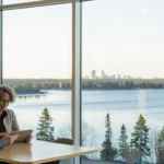 Two people review Minnesota Medicare Advantage plan options by a lake.
