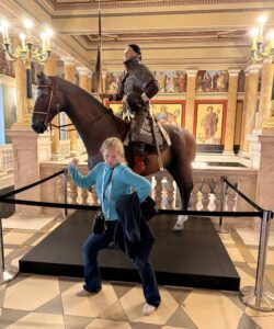 Quantz posing in front of a horse figure.