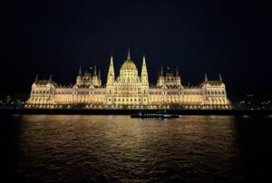 A beautiful building seen from a distance, lit up with bright lights.
