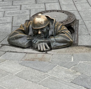 The image of a metal man coming out of the ground.