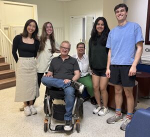 Karl's brother Rob surrounded by eager looking students.
