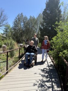 Three people walking through the gardens.