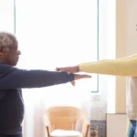 Senior woman doing physical therapy exercises with a therapist in a rehabilitation clinic