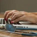 Senior couple reviewing Medicare plan documents with an insurance advisor at a table