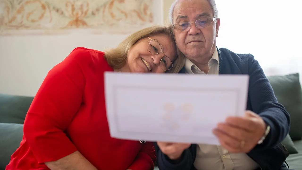 Senior couple discussing Medicare supplement plan options with healthcare paperwork