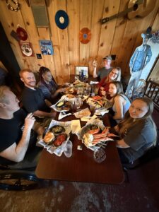 A group of people sitting at a table having a meal together.