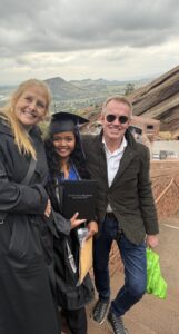 Miti surrounded by Quantz and Karl at Miti's graduation in Colorado.