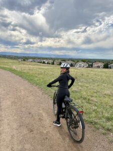Miti on a bike, looking back at the camera.
