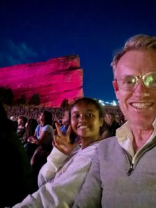 Miti and Karl at Red Rocks, waving at the camera.