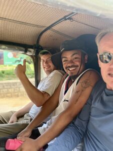 A group of three men sitting together in Madagascar.
