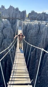Nicholas walking on an elevated ladder.