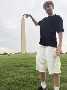 Justin with his finger at the top of the Washington Monument.