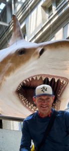 Karl in front of a shark model.
