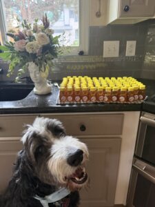 Plato standing in front of a group of small honey jars.