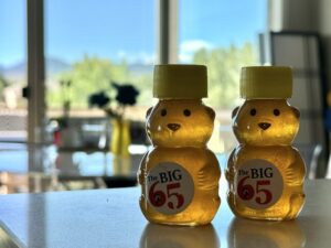 Two honey containers on a counter.