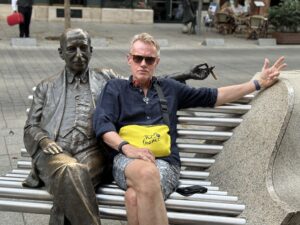 Karl wearing sunglasses while sitting on a bench.