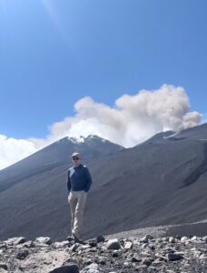 Karl standing near the rim of an active volcano.