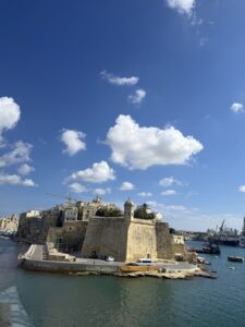 A historic building with white clouds in the distance.