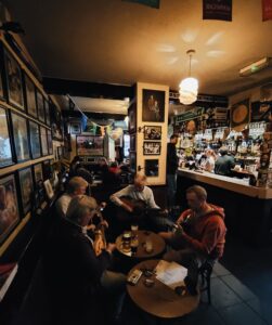 A group of musicians holding musical instruments in a pub in Ireland.